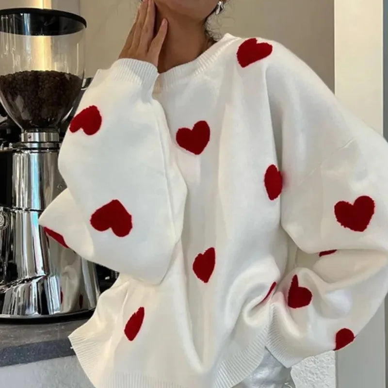 Soft pink women's hearts sweater with delicate heart pattern detail and relaxed feminine fit