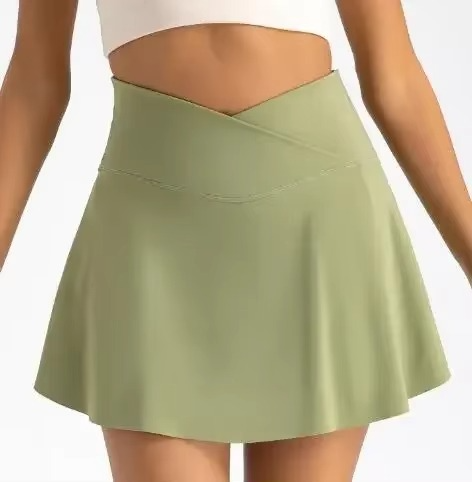 White high waist tennis skirt with built-in shorts, pockets, and compression fit for women