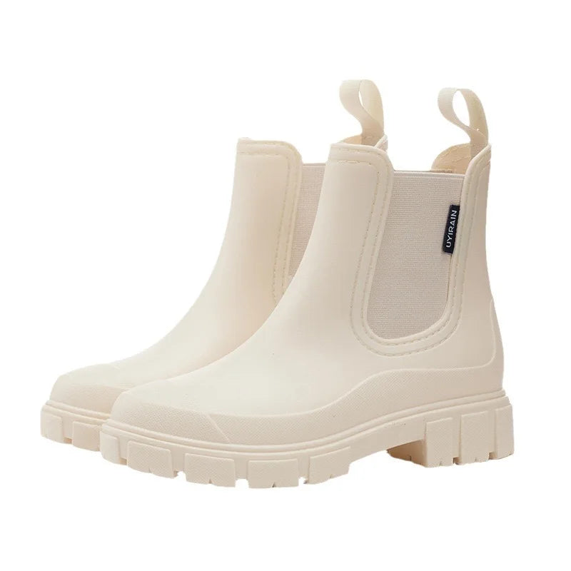 Women's black Chelsea-style rain boots with waterproof construction and elastic side panels