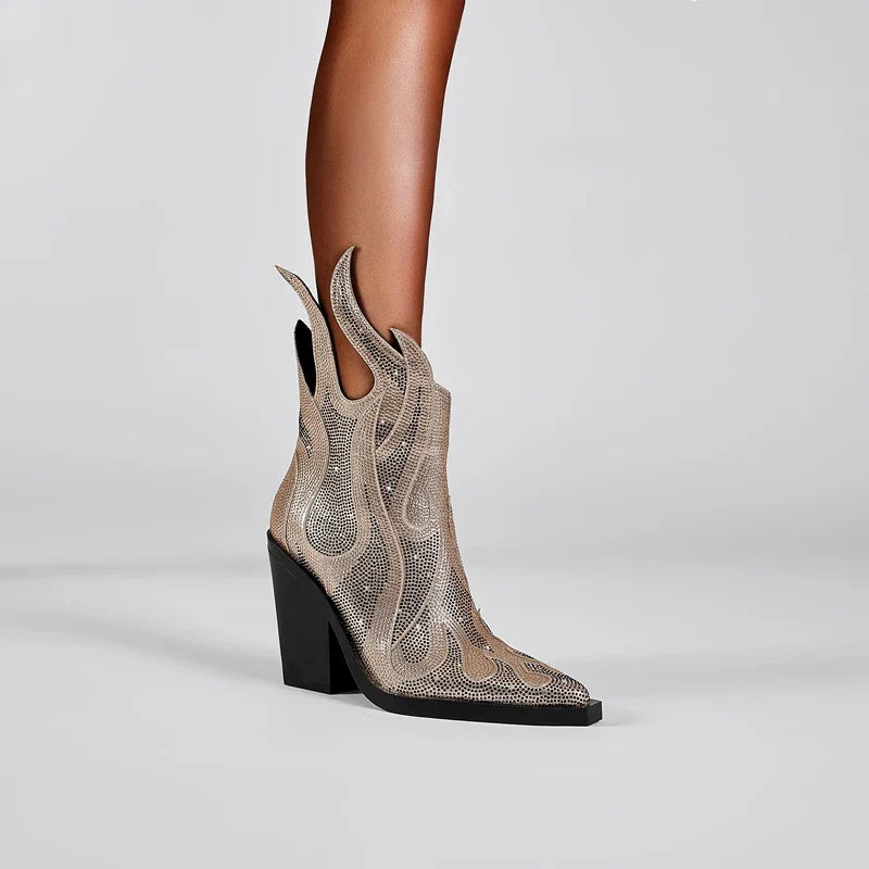 Black ankle boots with flame silhouette cutout design and rhinestone sparkle, bold stage-ready style
