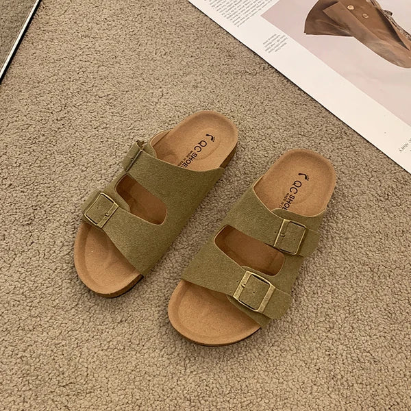 Women's cushioned slip-on buckle sandals in neutral tone with contoured footbed and elegant slide silhouette