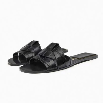 Women's cushioned flat slides with smooth minimalist straps in a lightweight versatile silhouette