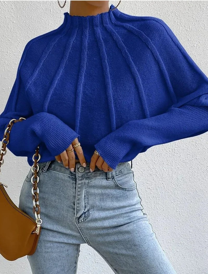Sunburst pattern ribbed knit mock neck sweater in warm tones with batwing sleeves and snug cuffs