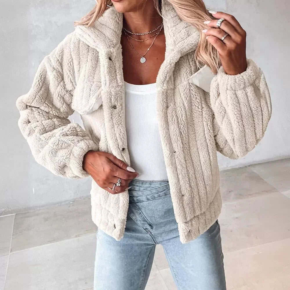 Cropped ivory faux fur trucker jacket with ribbed knit texture, wide turn-down collar, and cinched cuffs