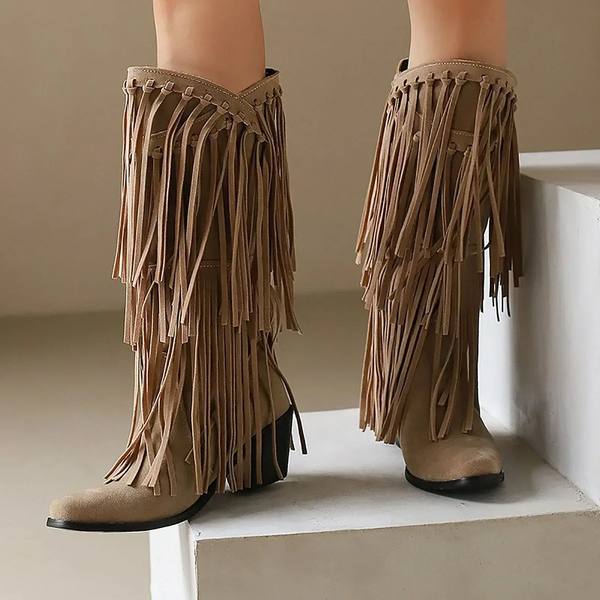 Women's brown fringe knee-high boots western style with block heel and flowing fringe detailing