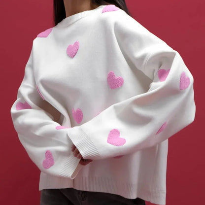 Pink women's heart print knit sweater with delicate embroidered accents and feminine relaxed fit
