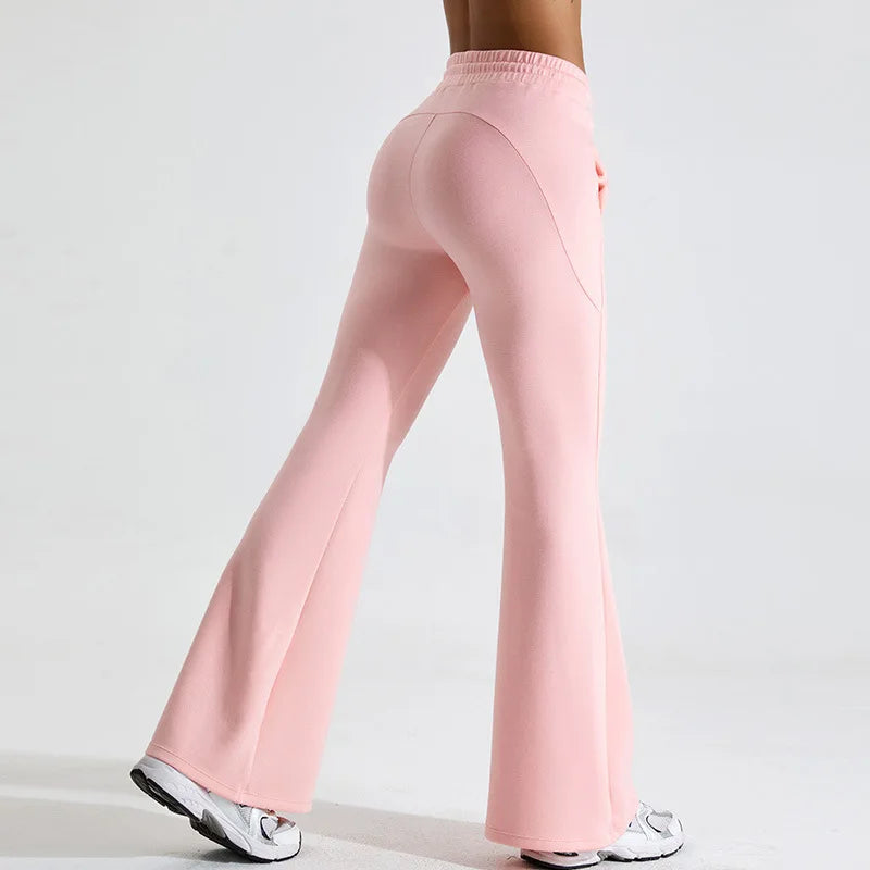 Black high-rise flared yoga pants in stretch performance fabric with body-contouring fit