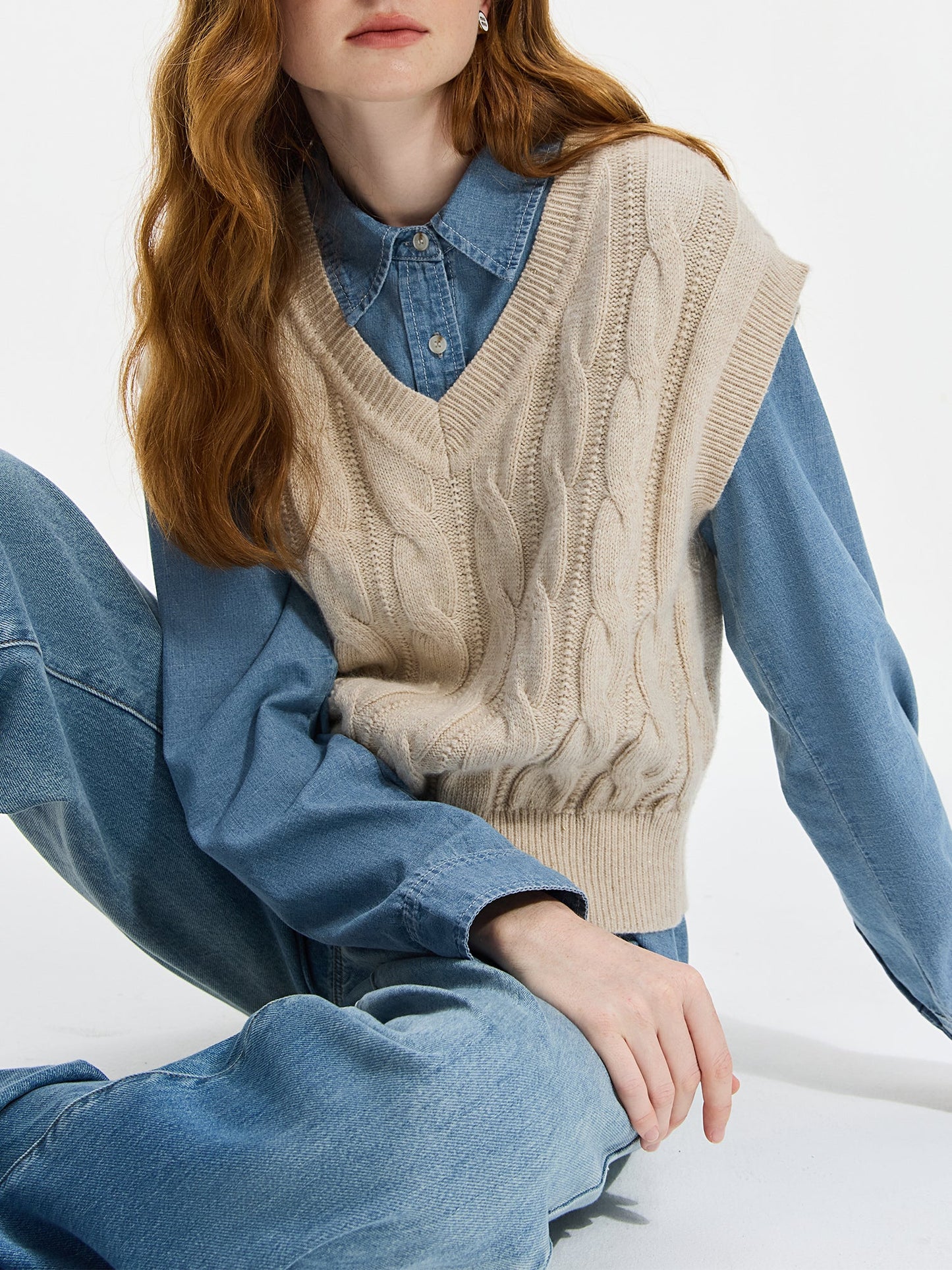 Ivory cable knit sweater vest with drop-shoulder silhouette and intricate woven pattern, preppy smart-casual style
