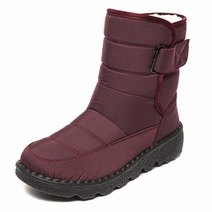 Women's mid-calf winter boots with velcro strap, plush insulation, and reliable cold-weather traction