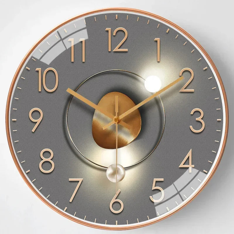 Golden tone modern wall clock with minimalist hour markers and elegant circular metal frame design