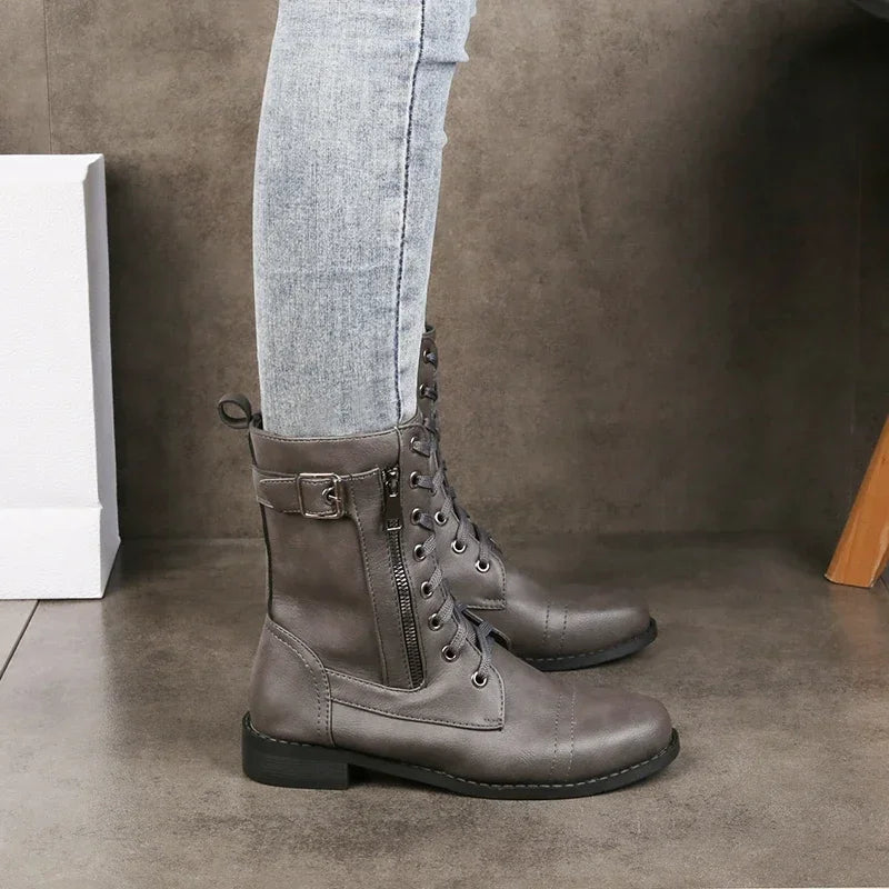 Black synthetic leather moto mid-calf boot with bold buckle accent, lace and zip closure