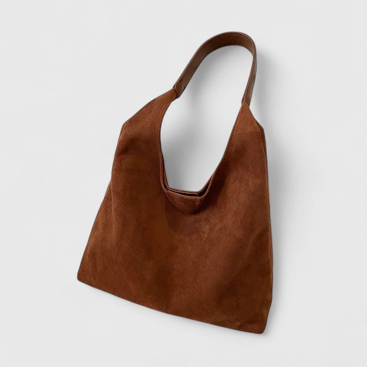 Minimalist beige shoulder bag with clean lines, structured silhouette, and single adjustable strap