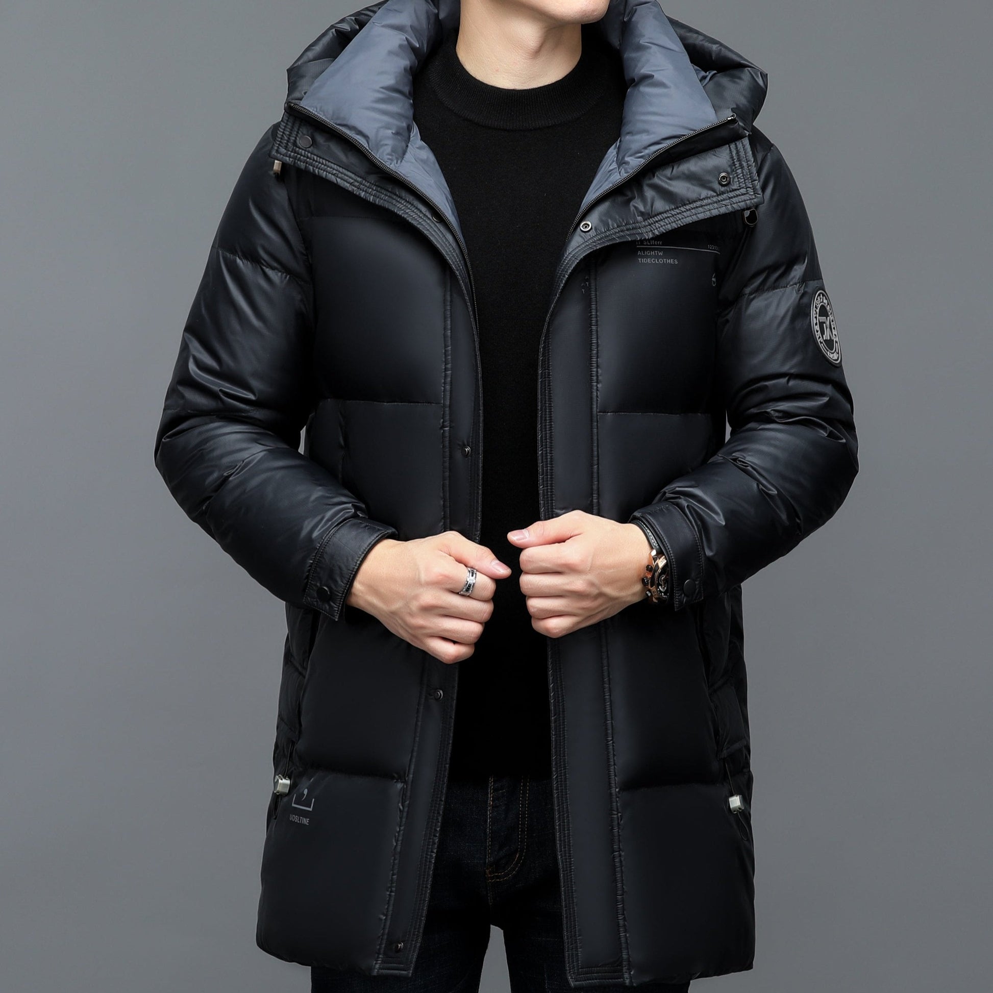 Black waterproof parka with 90% duck down insulation, sleek blacked-out shell, modern slim fit