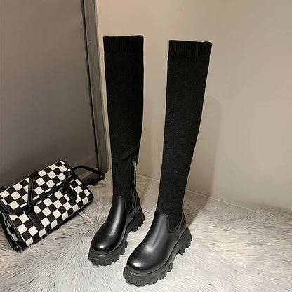 Women's black knee-high boots with chunky lug sole, sleek street-style silhouette for everyday wear