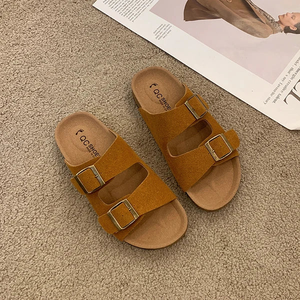 Women's cushioned slip-on buckle sandals in neutral tones with contoured footbed and elegant strap detail