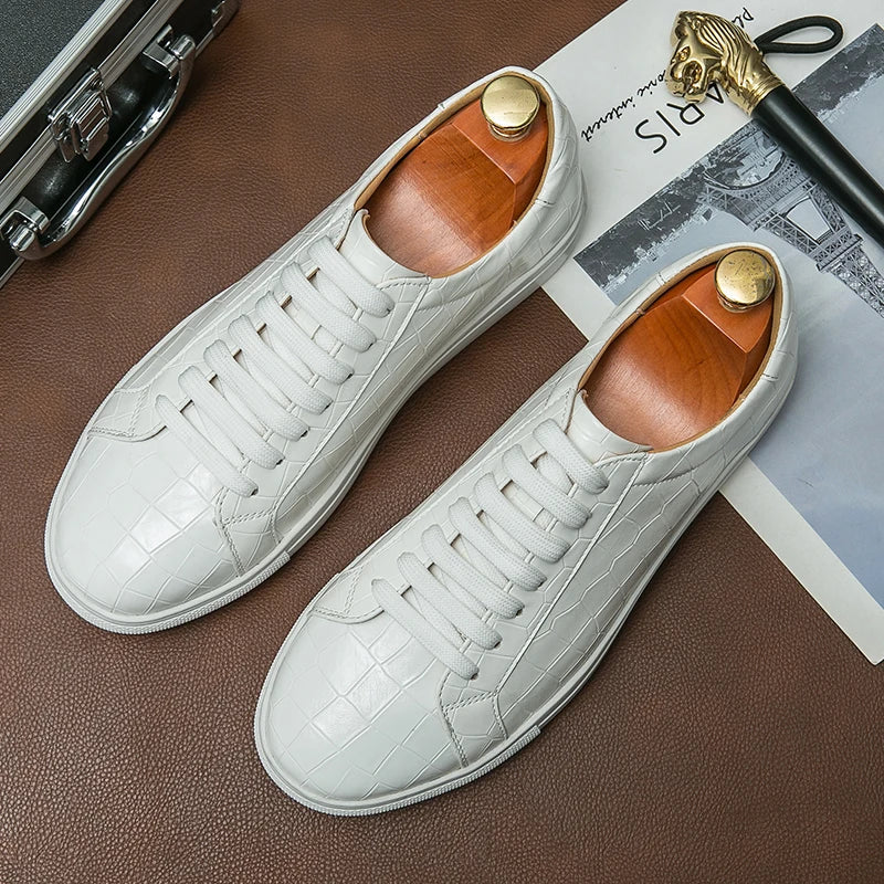 White low-top sneaker with embossed alligator texture on synthetic leather upper and cushioned rubber outsole