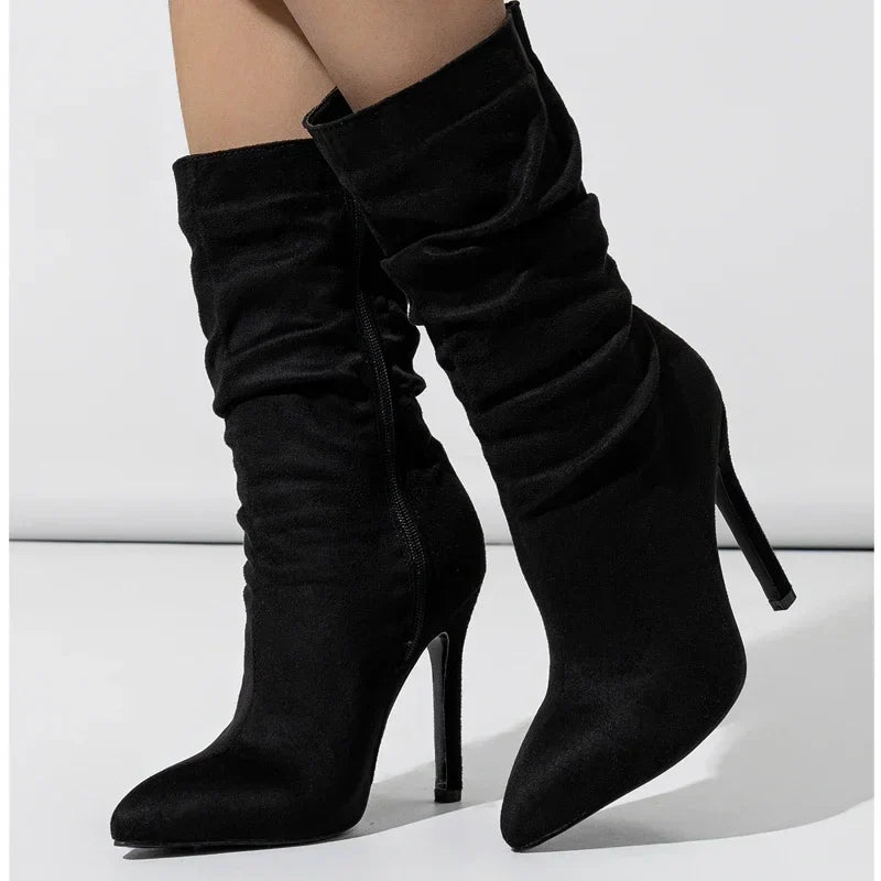 Black velvet stiletto boot with plush finish, sleek heel, and relaxed shaft for evening wear