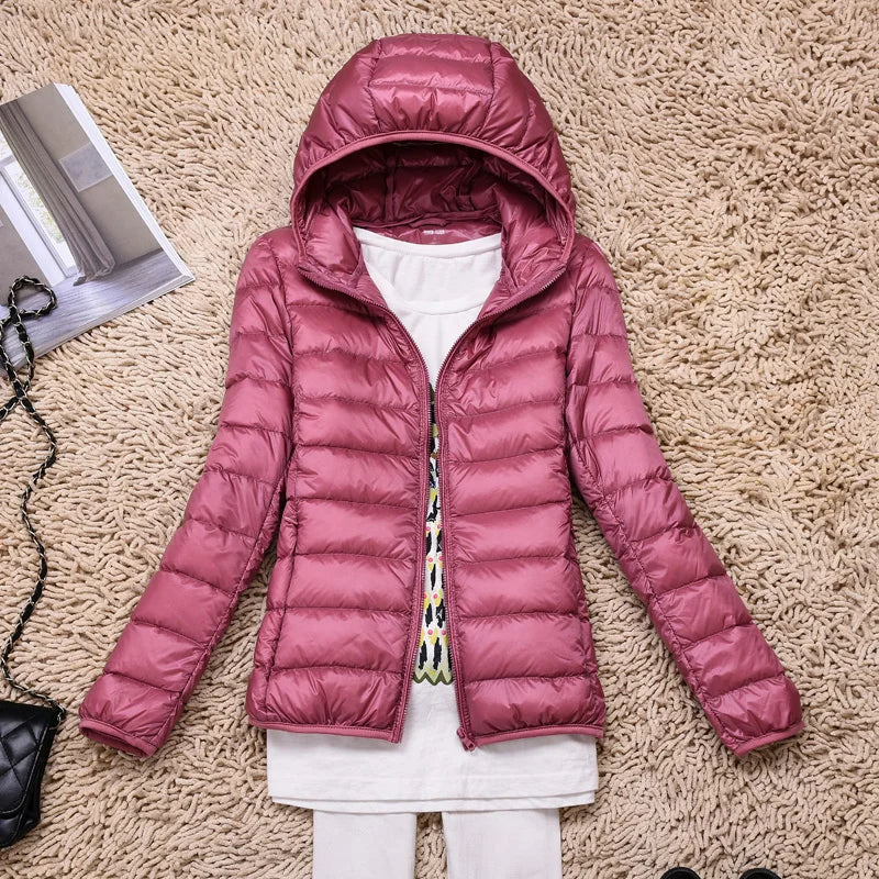 Women's quilted down jacket tailored hip-length fit with hood, lightweight warmth in neutral tone