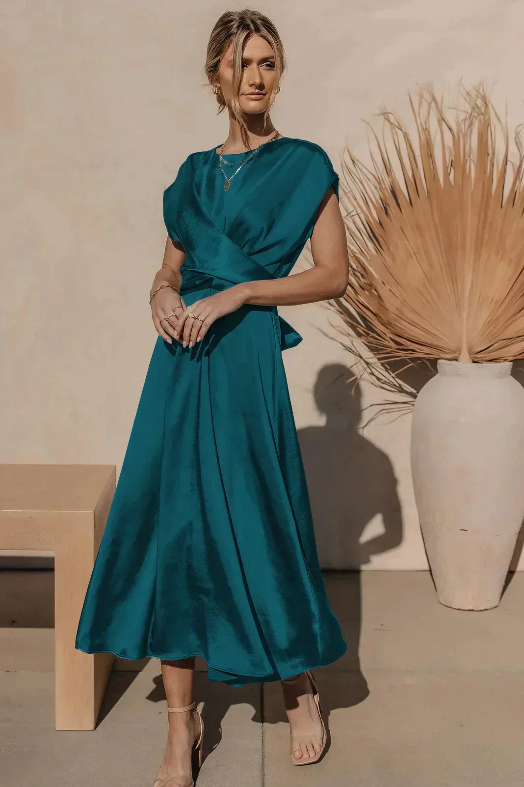 Women's satin midi dress in elegant A-line fit with V-neck wrap design and luxurious drape