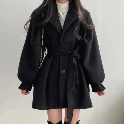 Beige Sadie trench coat with dramatic lantern sleeves, belted waist, and Italian-inspired elegant silhouette