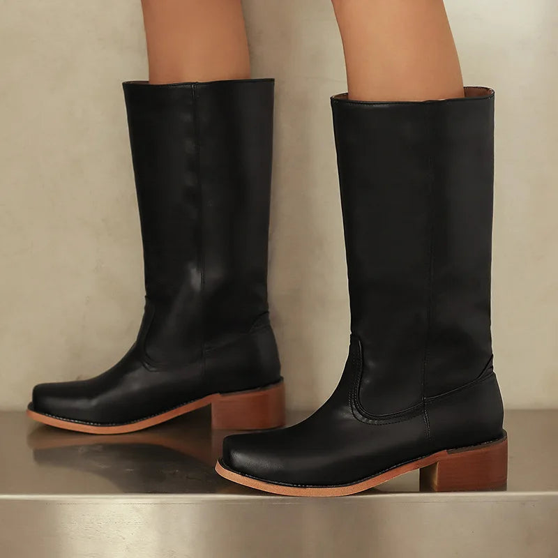 Black ankle-height comfort boots with sleek streamlined silhouette and supportive cushioned sole