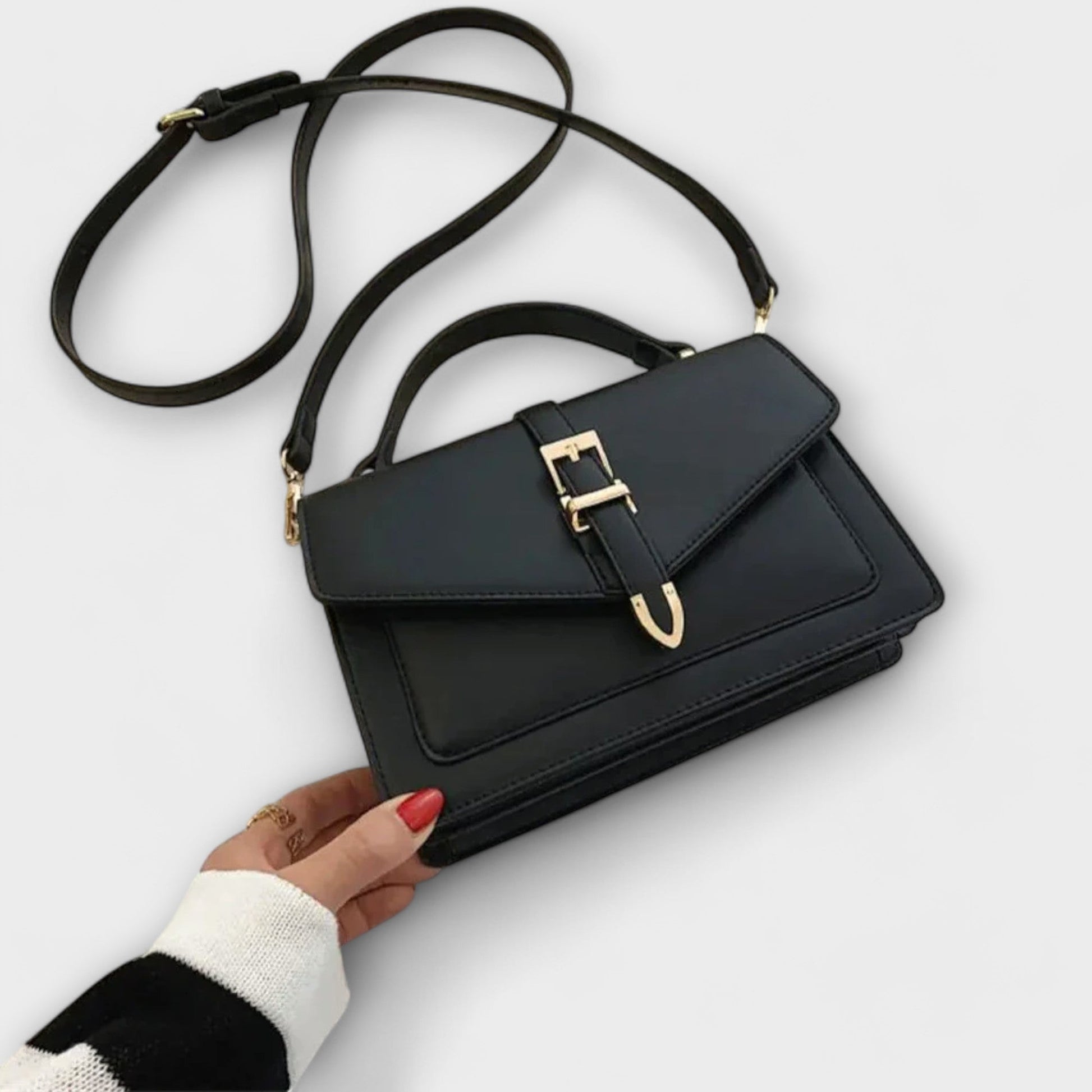 Classic structured shoulder bag in neutral tone with elegant gold buckle detail, compact and versatile