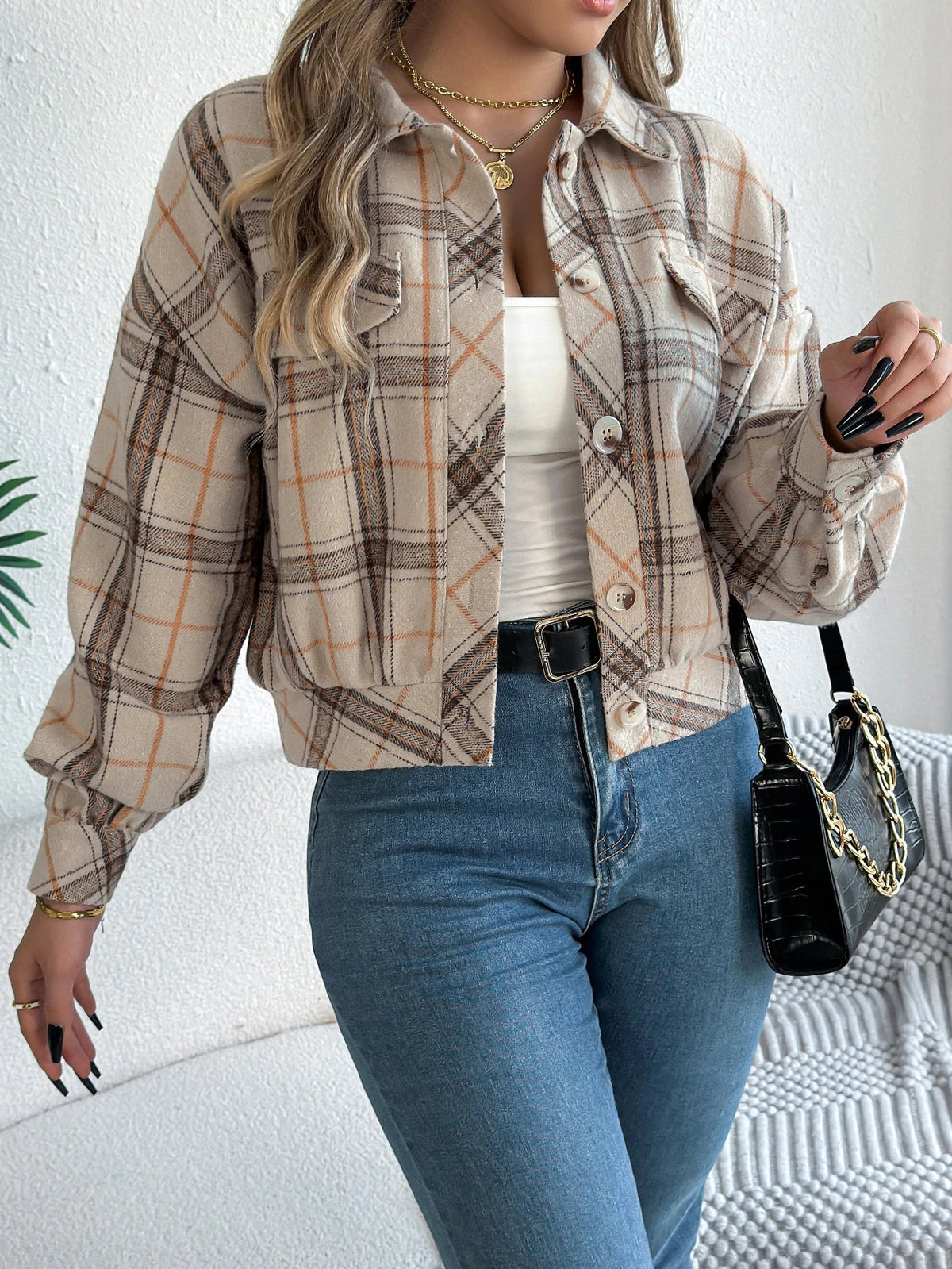 Cropped plaid jacket in warm tones with brushed fabric, draped sleeves, and faux horn buttons