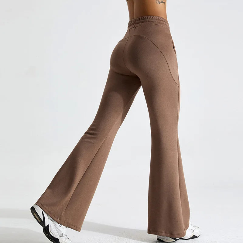 Black high-rise flared yoga pants in stretch performance fabric with contoured fit