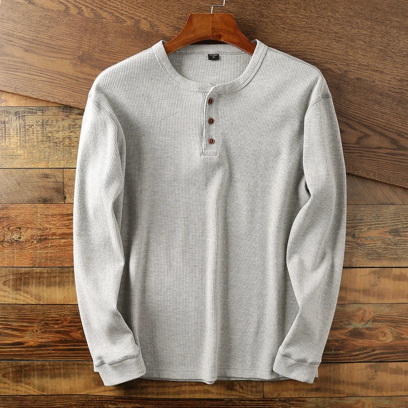 Cream waffle knit henley long sleeve shirt with minimalist button placket and premium cotton blend fabric