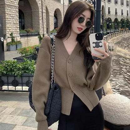 Cream ribbed knit sweater with relaxed sleeves, tailored body fit, and soft breathable fabric