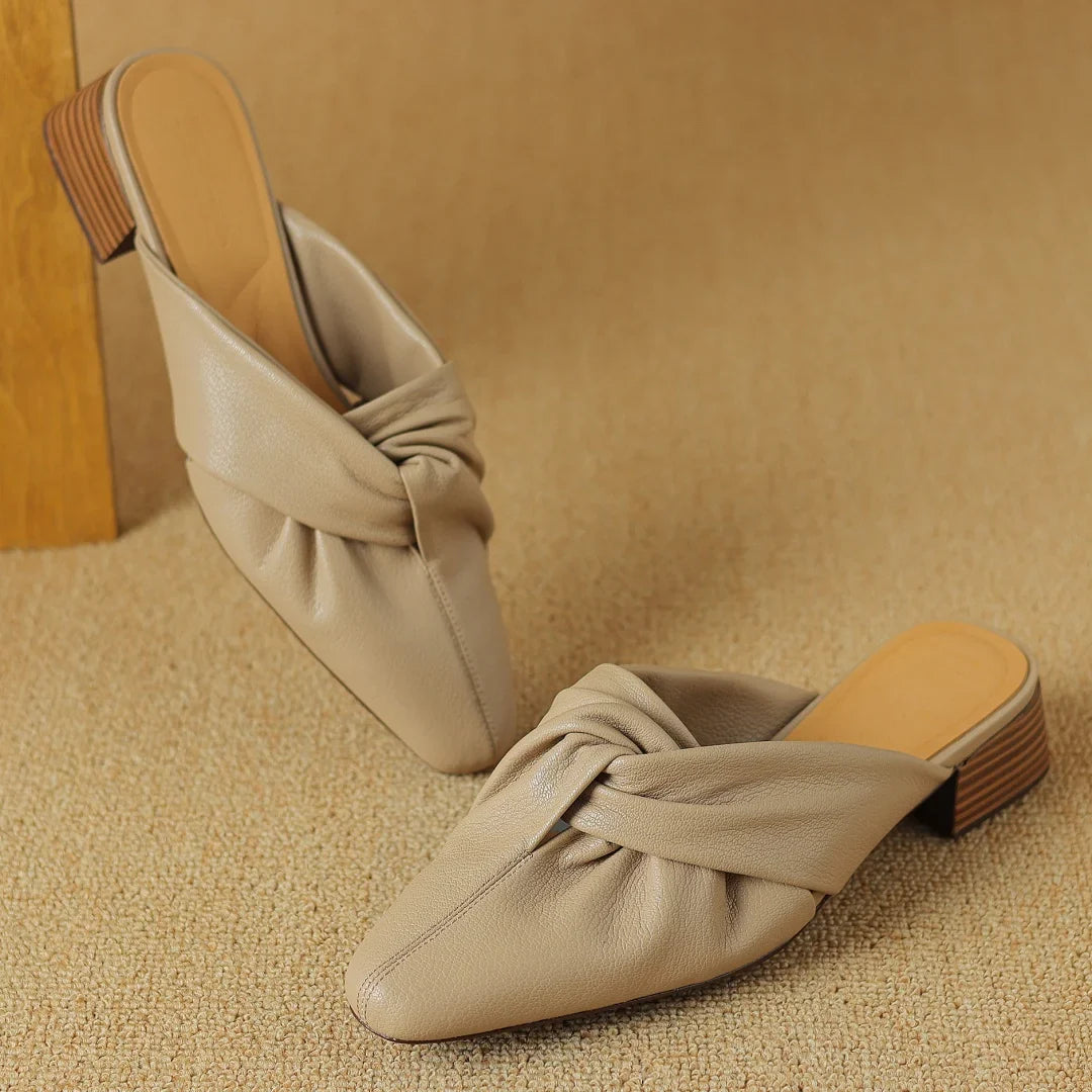 Genuine leather mules with signature bow-knot detail, textured finish, slip-on style for women