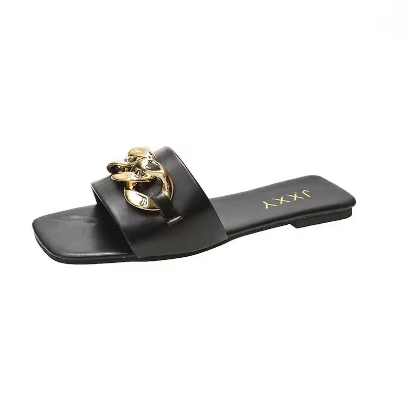 Women's vegan leather slide flats with bold gold chunky curb chain strap accent, summer chic style
