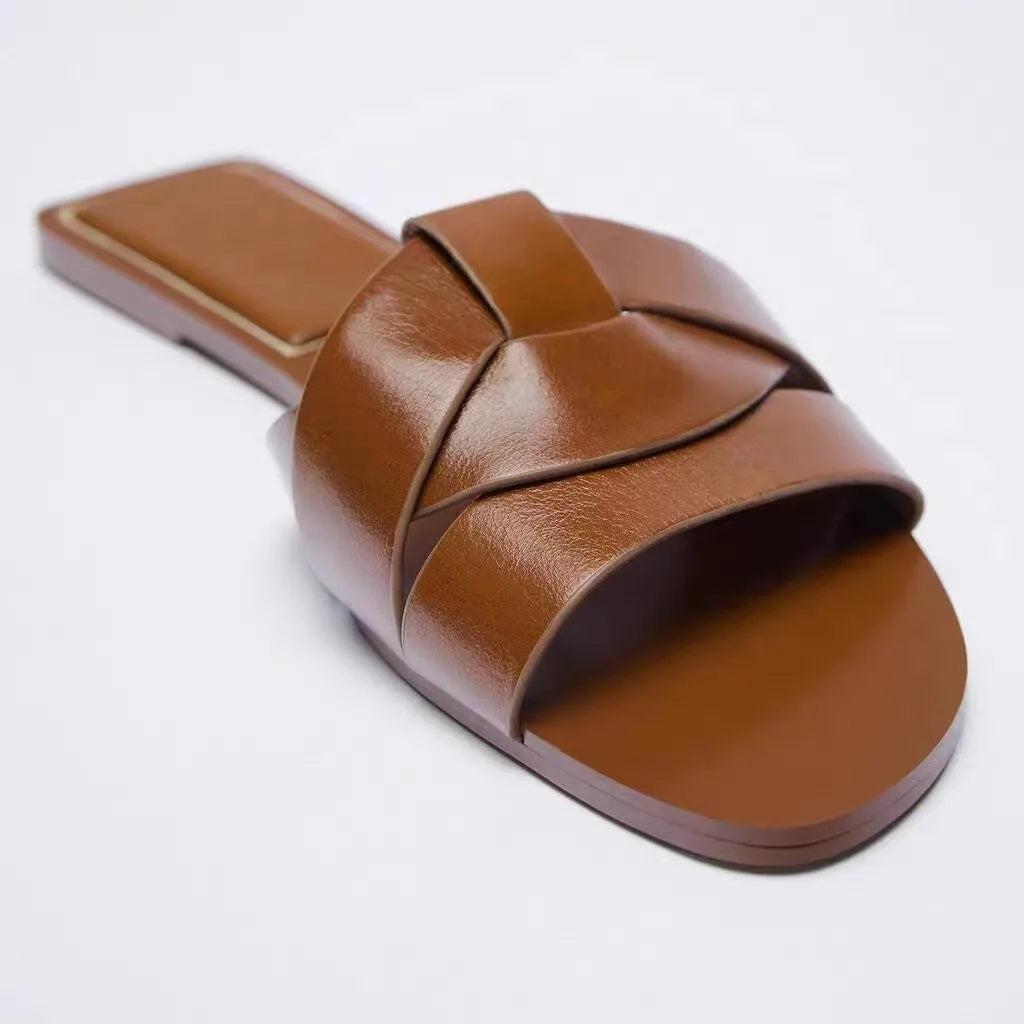 Women's cushioned flat slides with smooth minimalist straps in a lightweight versatile silhouette