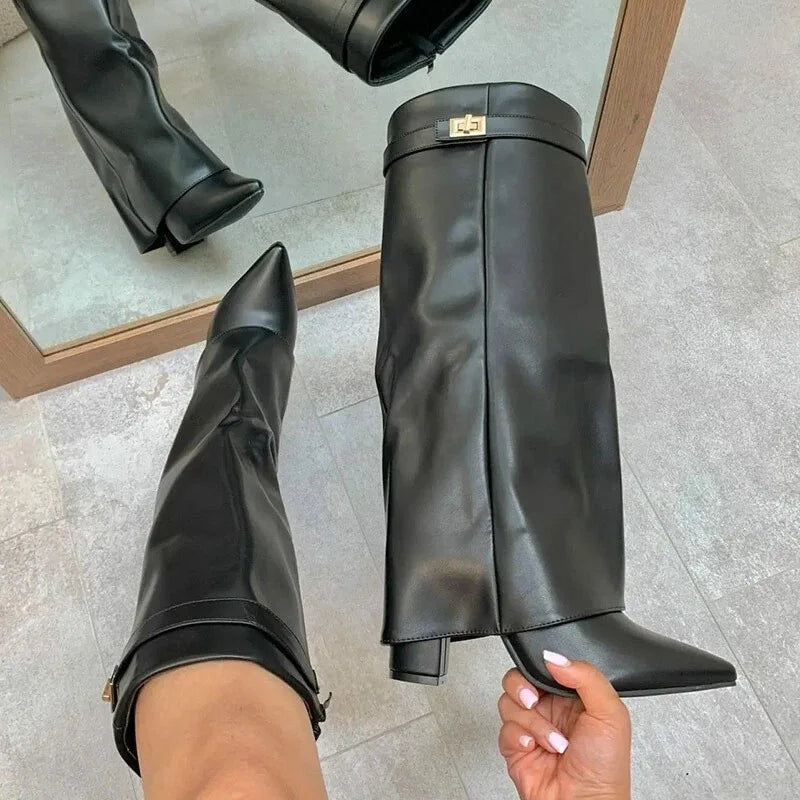 Women's black leather thigh-high boots with bold buckle detail, sleek fitted silhouette