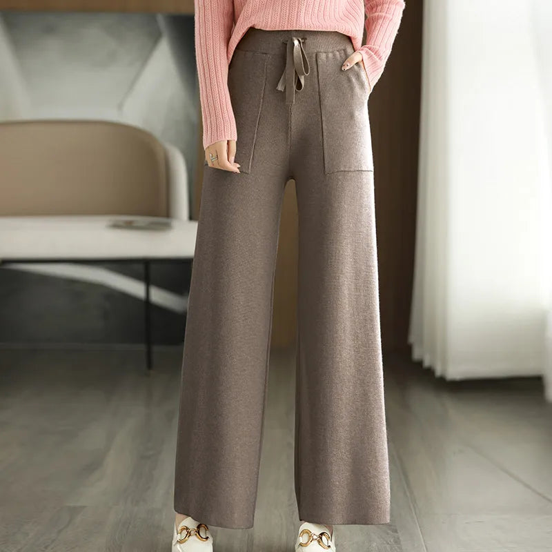 High waisted wide-leg wool pants in neutral tone with relaxed silhouette and flattering fit
