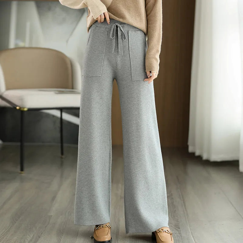 High waisted wide-leg wool pants in neutral tone with relaxed silhouette and flattering waistband