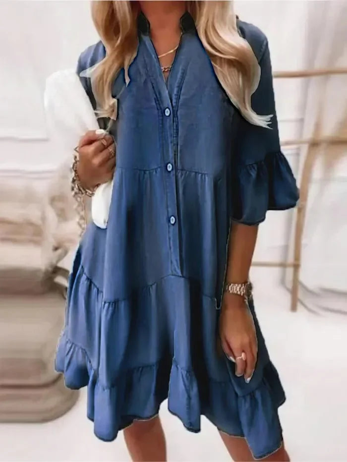 Light blue chambray tiered ruffle mini dress with flared sleeves and partial button-down front