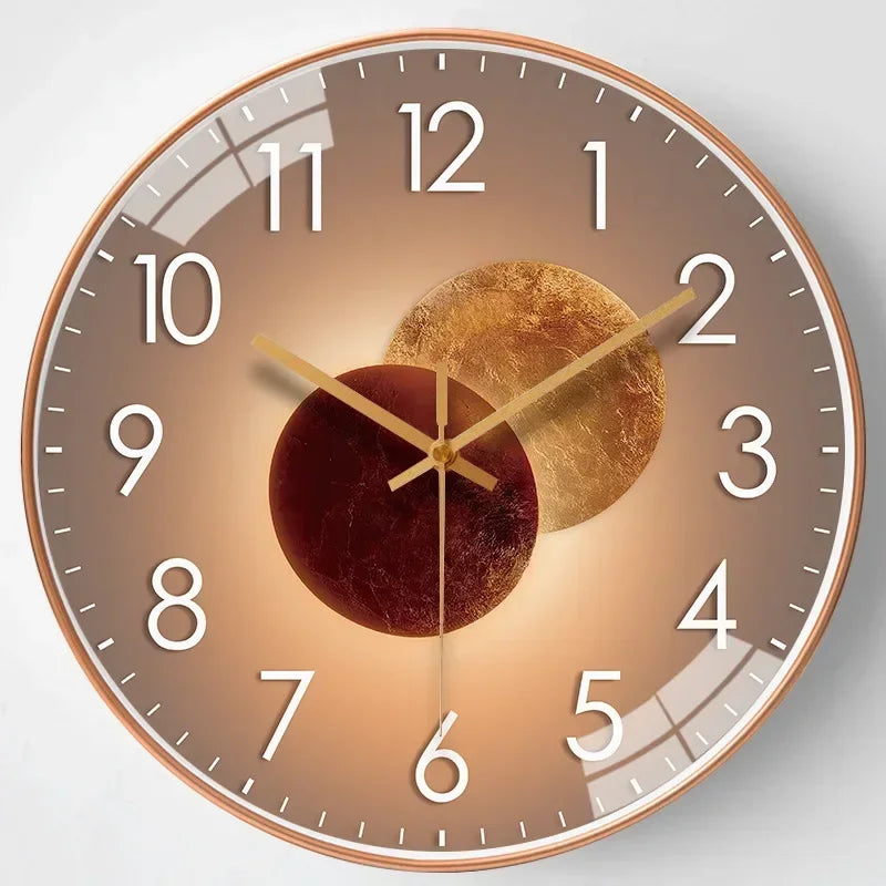 Golden tone metal wall clock with minimalist hour markers and modern circular glass design