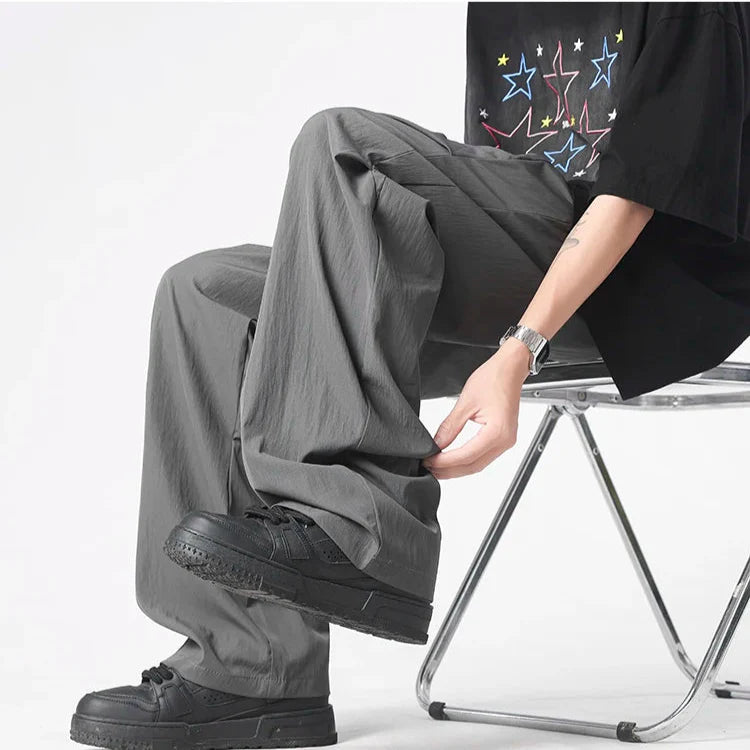 Neutral tufted parachute pants wide-leg relaxed fit chrome-tip drawstrings lightweight crinkled nylon streetwear