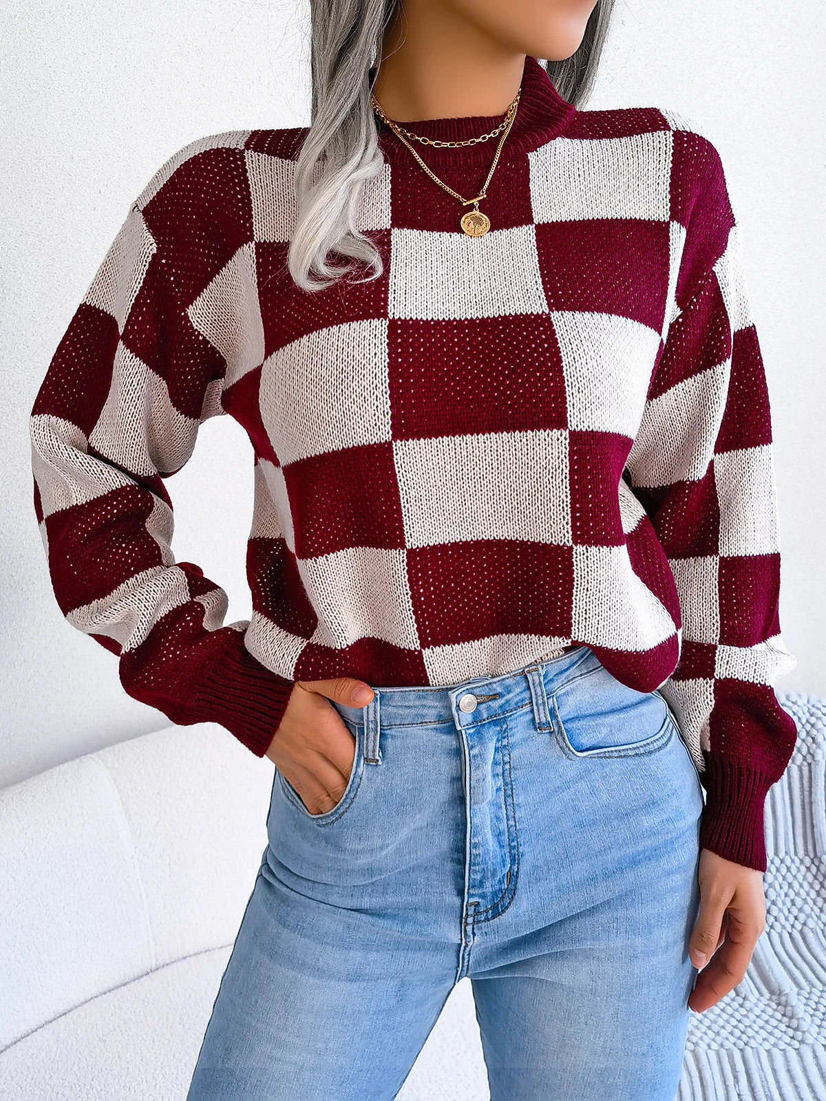 Relaxed checkered knit sweater in warm beige and ivory tones with retro-inspired unisex fit