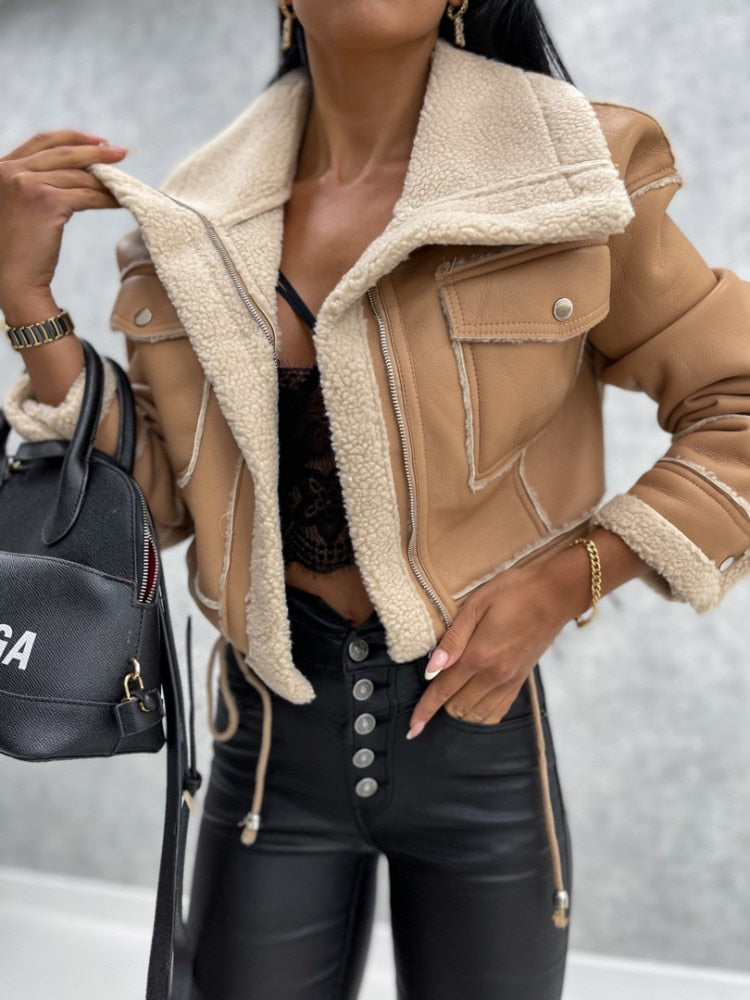 Women's cropped faux leather jacket with shearling lining, slim fit zip closure, edgy chic style