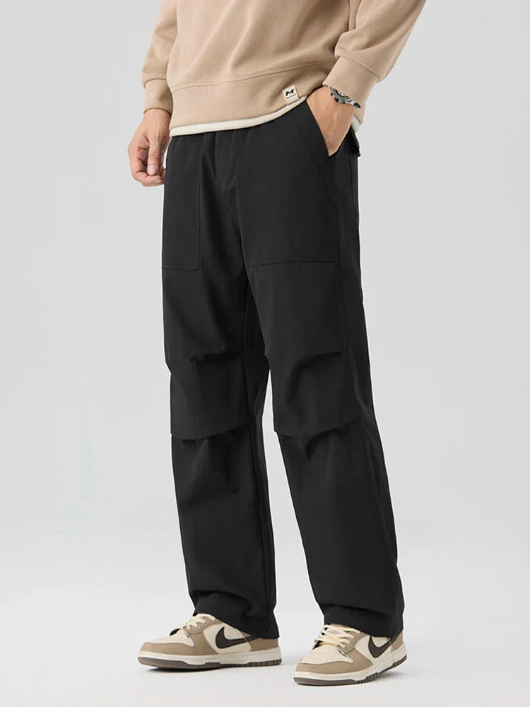Water-resistant nylon cargo pants with grid weave texture, elastic waistband, and deep utility pockets