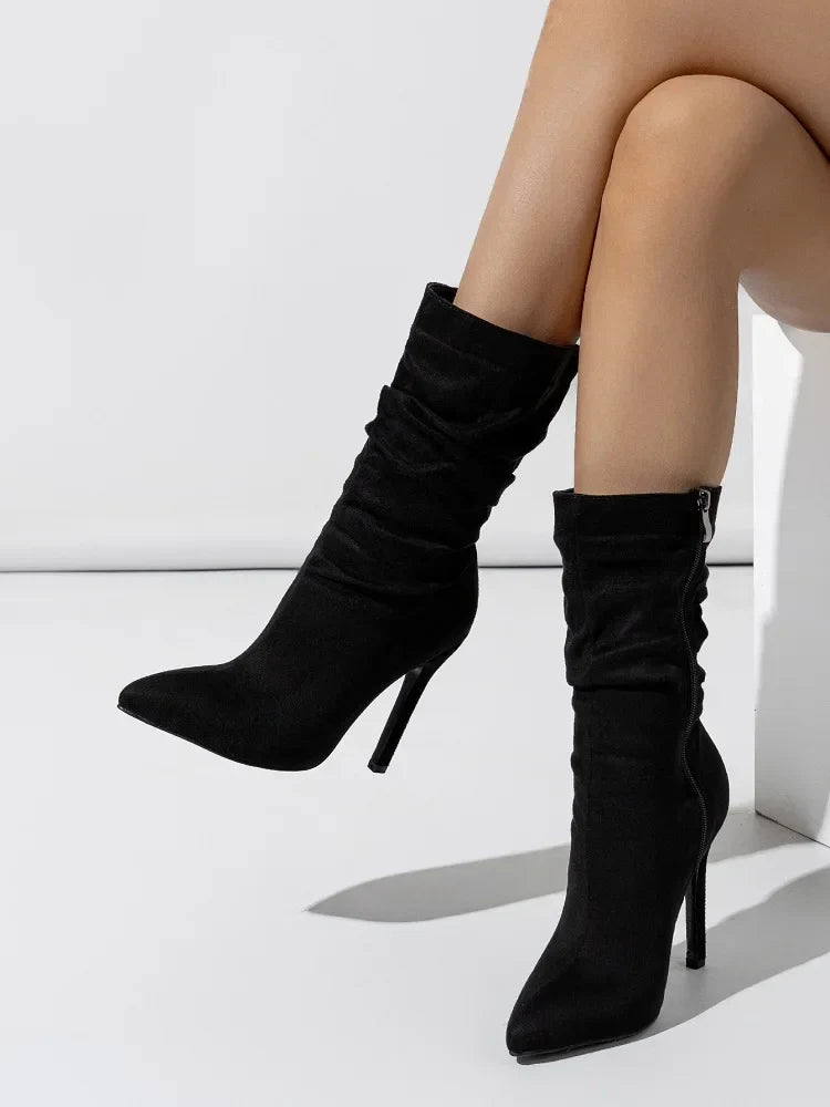 Black velvet stiletto boot with plush finish, sleek high heel, and relaxed shaft for evening wear