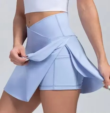 White high waist tennis skirt with built-in shorts, pockets, and compression fit for women