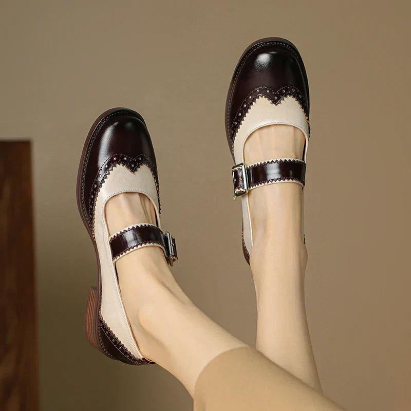 Women's two-tone leather Mary Jane shoes with brogue scalloped edges and T-strap buckle closure
