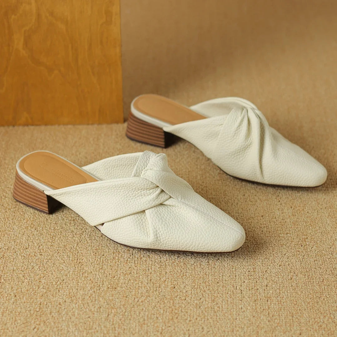 Genuine leather mules with signature bow-knot detail, textured finish, slip-on style for women
