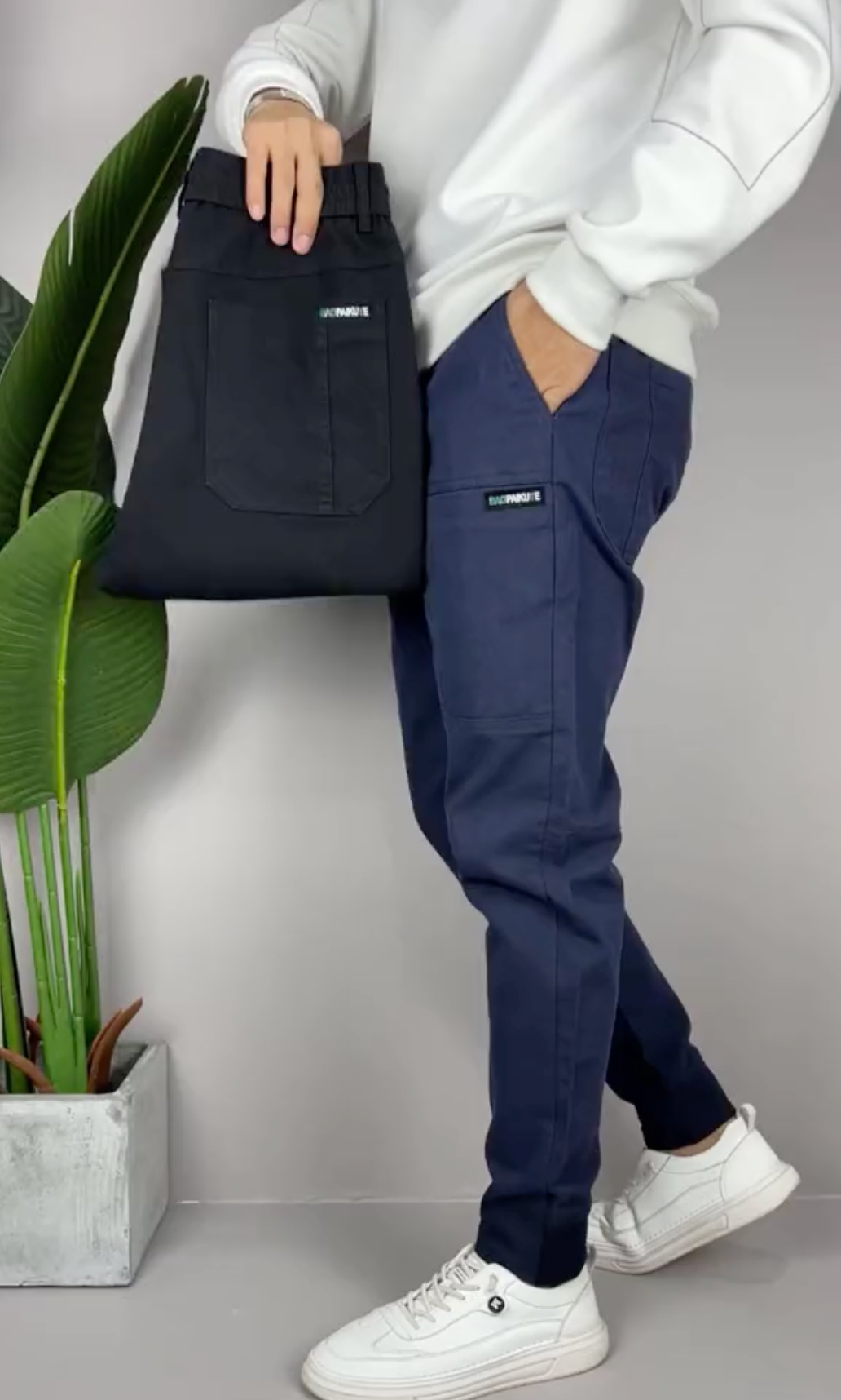 Men's stretch cargo pants in neutral tone, slim tapered cut with multi-pocket utility design