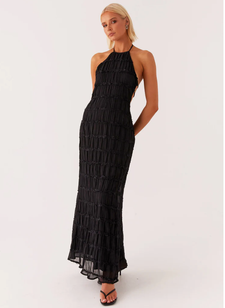 Elegant black halter maxi dress with flowing skirt, flattering neckline, perfect for weddings
