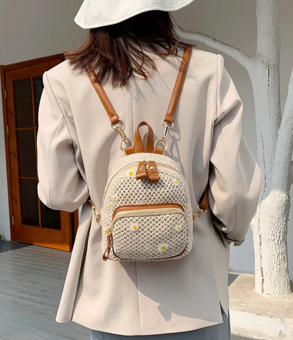 Petite Floré handwoven straw backpack with daisy floral embroidery, compact lightweight women's bag