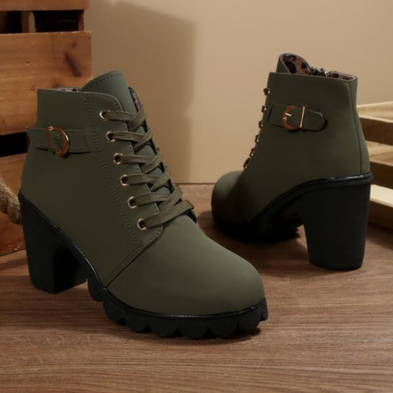 Black chunky ankle boots with lace-up design, block heel, and bold supportive sole for edgy style